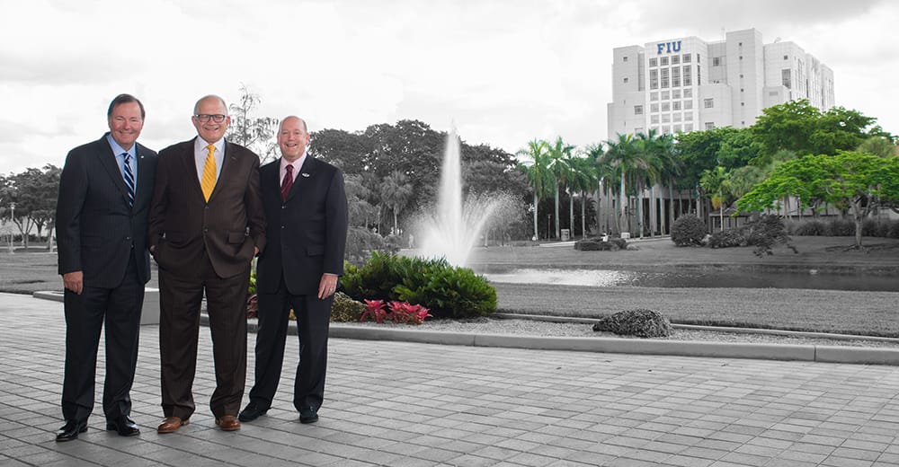 Cornish, Rosenberg, and Lipman standing in front of Florida International University