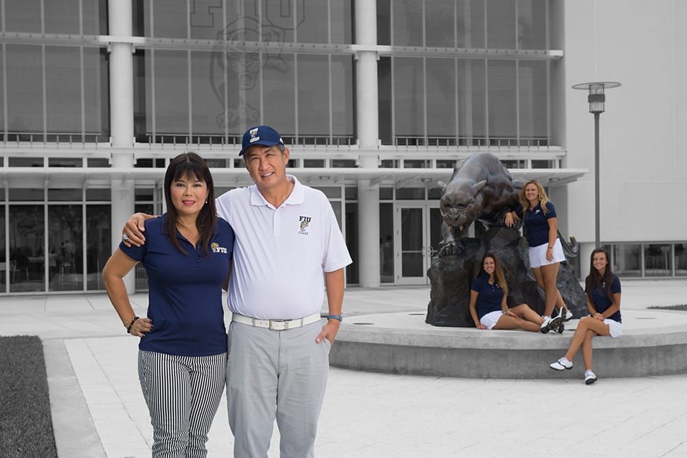 Wilson and Lirian Dondo posing in front of Florida International University